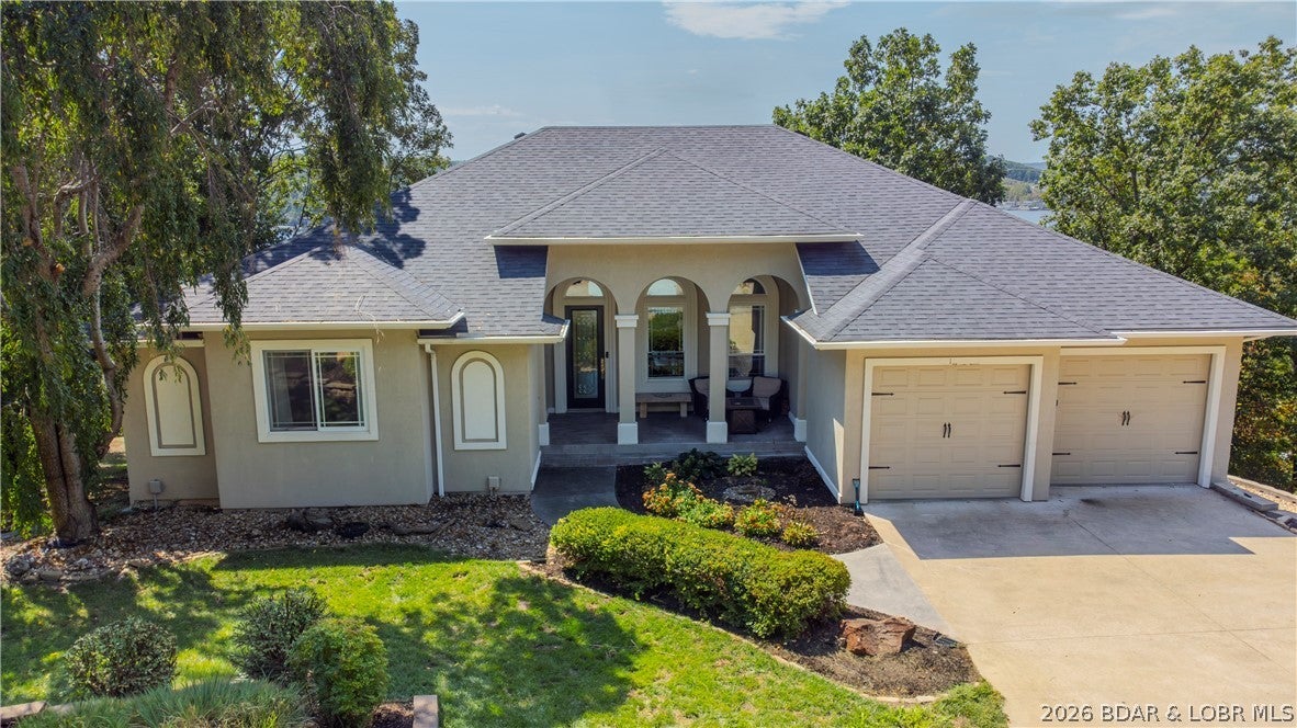 Welcome to this exceptional private lake view/access residence situated in a highly desirable, peaceful, subdivision.  Upon entering the front door a grand living space that showcases a cozy fireplace and a dramatic bank of soaring windows framing a panoramic view promise to take your breath away.  A kitchen built for gourmet cooking and entertaining boasts a generous island, and a walk-in pantry. The main level features a lake view suite complete with a beautifully appointed bathroom and spacious walk-in closet.  A flexible guest bedroom with an en suite bath can also serve as a main floor office. A commercial-grade elevator has been recently installed for the ease of living on both levels. Two additional lake view bedrooms with bathrooms on the lower level as part of a space that shares a wet bar, family room w/ additional fireplace, and a workout room. Outdoor spaces are remarkable offering 790 sqft of main-level concrete patio space alongside a 650-square-foot lake view screened porch below with private hot tub. The yard is gently sloped and irrigated. An additional 1 car garage on lower level, and  14x34 boat slip adjacent the newly paved, golf-cart-accessible, boat ramp.