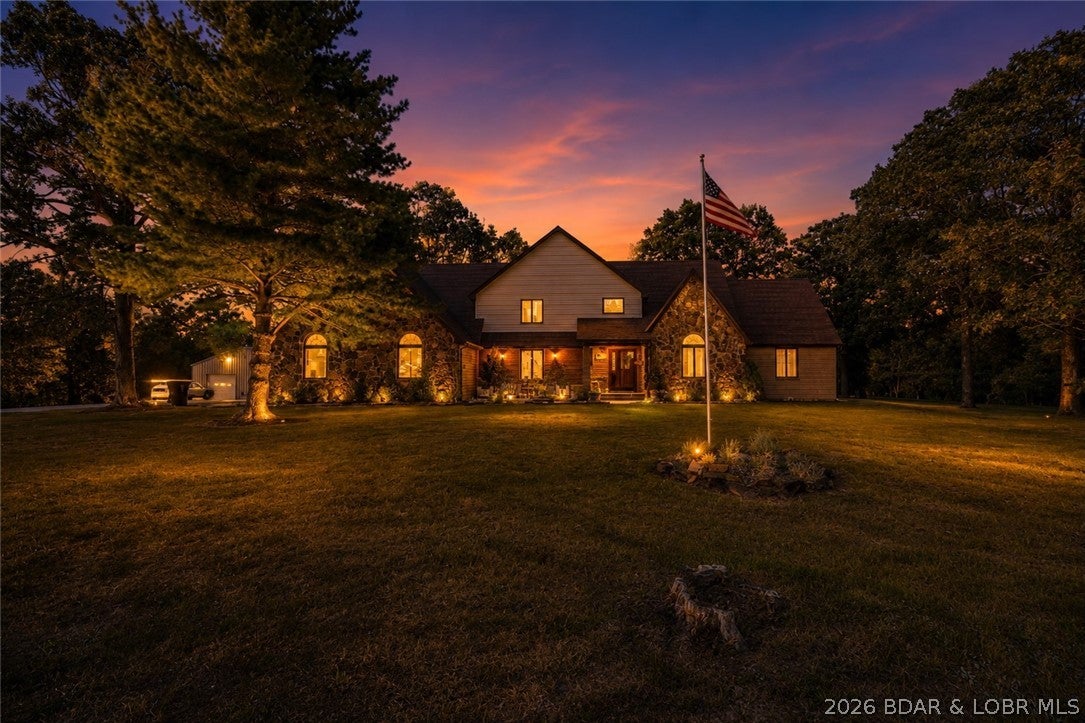 Discover the space, privacy and versatility of this brick and stone Craftsman-style home on 7.5 flat, cleared acres in Eldridge, with convenient proximity to the Niangua River. Offering approximately 4,200 sq ft, this 4-bedroom, 2.5-bath home features oversized bedrooms, an oversized chef’s kitchen, Soapstone wood-burning stove and multiple deck spaces overlooking the property. The attached 3-car garage provides convenient everyday parking, while a detached garage offers additional storage and potential to insulate and finish for additional usable space. A detached chicken coop and flourishing garden beds add to the property’s appeal for gardening, homesteading or simply enjoying the outdoors. As of May 2026, upper level and lower level HVAC units and ductwork are all new/replaced. With substantial living space, multiple outbuildings, established gardens and usable acreage, this property offers a rare combination of a spacious Craftsman-style home, versatile rural land and access to the Niangua River area. Located nearby popular attractions, including 12 miles to Ha Ha Tonka, 22 miles to central Lake of the Ozarks and 24 miles to Bennett Springs State Park.