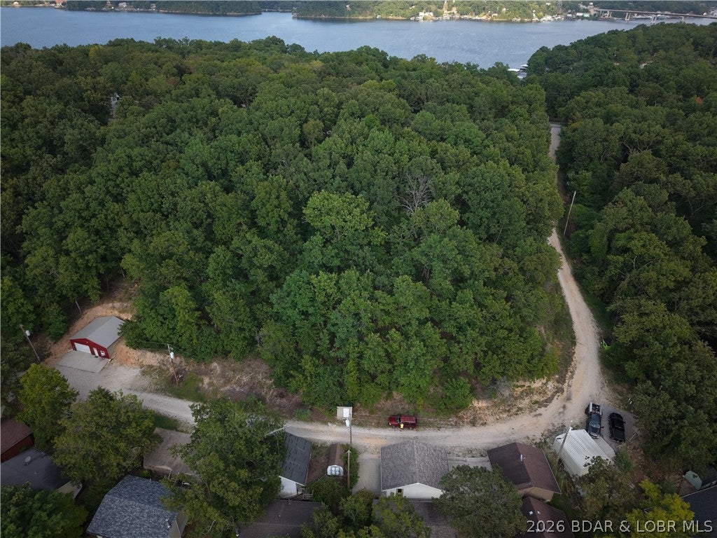 Build your lake getaway on this 0.112-acre wooded lot offering elevated views of Lake of the Ozarks around the 35 Mile Marker. The property sits high enough to capture a great lake view while still giving you the privacy and character of a wooded setting. Located just off Highway 5 between Sunrise Beach and Greenview, this lot offers convenient access while keeping you close to the lake.

Electricity is available at the corner of the property near the community well. The community also has a shared dumpster and well that may be available for use with community approval. A great opportunity for someone looking for an affordable lake-view lot in a convenient location.
