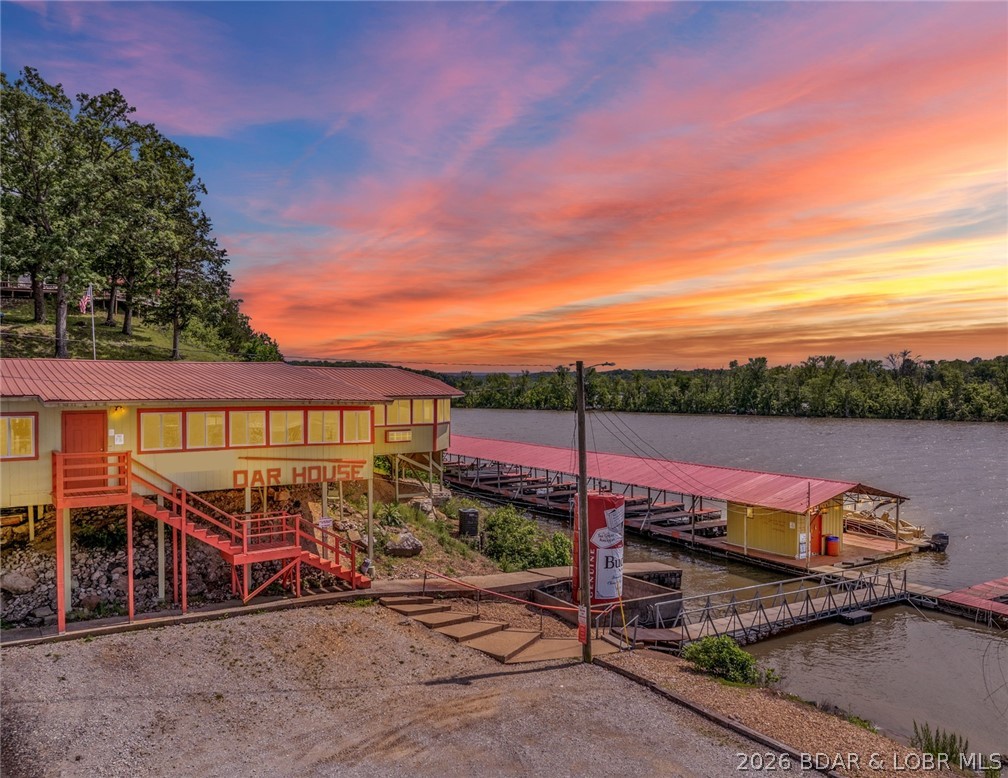 The Oar House, a well known destination at the 81mm of the Lake of the Ozarks. This resort has been a favorite waterfront venue for years, with a 96-seat restaurant/bar, customers would savor delicious food & drinks. Daily specials kept things exciting. On select weekends, customers enjoyed live music that added to their dining experience. The resort has hosted Bingo events, fishing contests, and participated in poker runs. The marina is open Fridays - Sundays with bait shop/convenience store to cater to all your boating needs, offering fuel for boats & PWC, 29 rentable boat slips. Buy essentials like ice, drinks, snacks, & beer before heading out on the water. The resort offers 36 RV sites. If you prefer, 6 updated motel units & a cabin are available for rent. This marina, restaurant, motel, campground, & guest house is located on the Osage Arm of Lake of the Ozarks, offering 2,366 feet of lakefront. The Oar House presents endless possibilities for relaxation & adventure. This is an investors dream to have 5 sources of income in one investment! There have been many updates on this property making it a Turn Key investment. Property is being sold As Is, Cash or Owner financed!