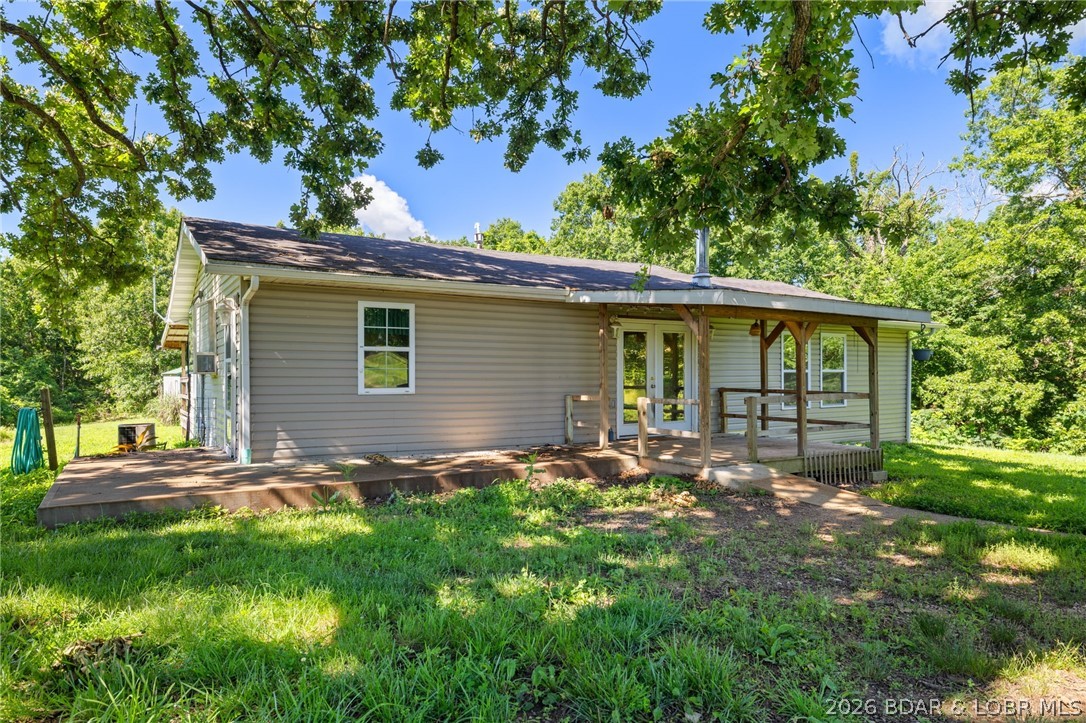 Unrestricted Ozarks property with income potential just minutes from Lake of the Ozarks and Ballparks National! This 2-bedroom, 1-bath home offers a rare combination of affordability, flexibility, and opportunity with NO RESTRICTIONS and ALL RENTAL TYPES ALLOWED. Ideal as a primary residence, Airbnb, vacation rental, long-term rental, weekend getaway, hunting retreat, or investment property. The home features a spacious open living area with wood stove, large kitchen with island, partial basement, covered front porch, covered back deck, storage shed, and well house. A separate 1-bedroom, 1-bath apartment with kitchenette provides additional income-producing potential, guest quarters, multigenerational living, or private office space. Conveniently located near Lake of the Ozarks boating, fishing, dining, and entertainment, as well as Ballparks National, making it attractive to vacationers, baseball families, and investors. Bring your imagination and add your personal touches to this as-is property. Endless possibilities, strong rental potential, and priced to sell. Schedule your private showing today!