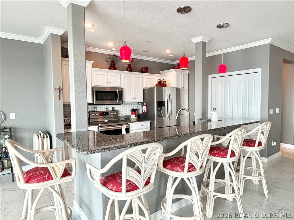Rare opportunity to own one of the highly sought-after “wedge” condos at Millstone Condos, located at the 7MM of the Lake of the Ozarks main channel. Offering an impressive 2,667 square feet, this spacious 4-bedroom, 3.5-bath condo features two primary suites, each with beautiful lake views. Fully furnished. The parking lot-level location means NO STEPS to enter, while an elevator provides easy access to the pool and lake. Enjoy the lake lifestyle from the oversized screened-in deck, complete with a convenient storage closet. An OVERSIZED GARAGE with abundant overhead storage is located just outside the unit. A 12x32 boat slip with a 6,000-lb lift is included and protected by a breakwater. Millstone offers a full-time maintenance staff and a convenient location close to popular lakefront restaurants, bars and entertainment. Condos of this size and style rarely become available—don’t miss your chance to make this exceptional lake retreat your own!