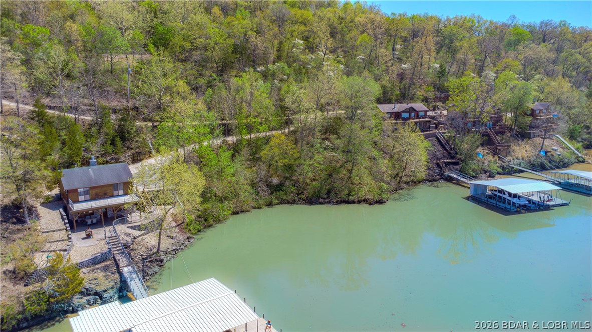 Build your dream lake escape on this stunning lakeview lot tucked away on the quiet side of Lake of the Ozarks. Offering breathtaking views—wide water, peaceful surroundings, and a level of tranquility that’s getting harder to find. Whether you're envisioning a full-time residence or a weekend retreat, this property provides the perfect setting to create something truly special—where mornings start with coffee overlooking the water and evenings end with sunsets and stillness. There’s room to design a space that fits your lifestyle, surrounded by nature and privacy, yet still close to everything you love about the lake lifestyle. By water, you’re near favorites like The Cave Restaurant, Nauti Fish Rum Bar, and Larry's on the Lake, along with the iconic Bridal Cave. By land, enjoy breakfast at Rise & Shine Cafe and explore the trails and castle ruins at Ha Ha Tonka State Park, then choose from the Hillbilly Hut or the Burger Basket on your way home. This is the quieter side of the lake—where the pace slows, the views stretch wide, and the experience feels like the lake was meant to be. POTENTIAL ADDED BONUS!!! An adjacent lot is also available to expand your footprint.