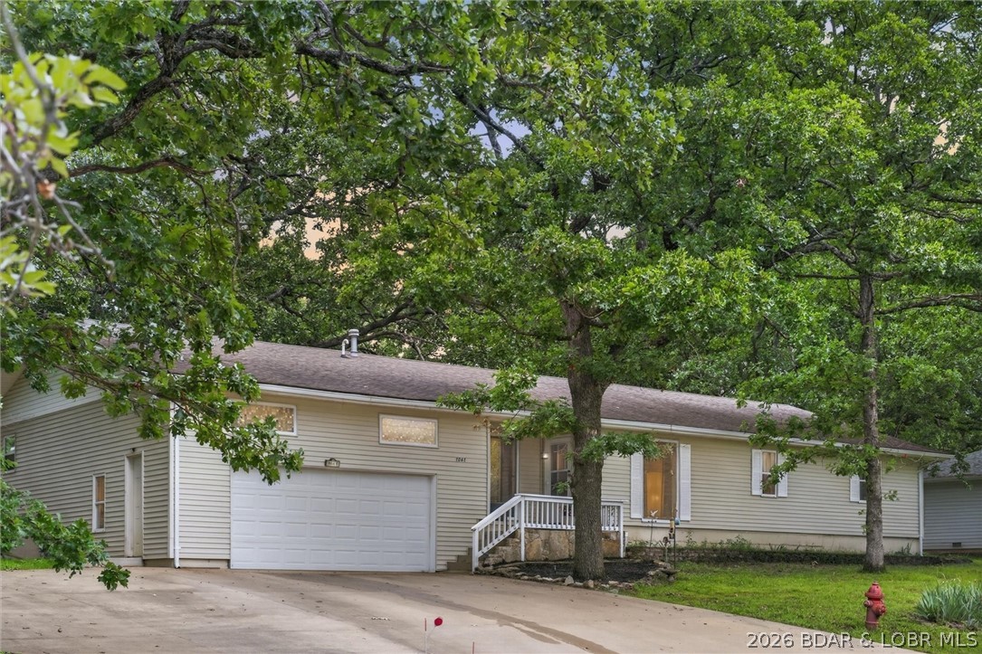 Welcome to lake area living in the heart of Camdenton. This spacious 4-bedroom, 3-bath home offers over 2,000 square feet of comfortable living space with updated finishes and plenty of room to spread out. The functional floor plan features a spacious living area filled with natural light, a well-appointed kitchen complete with a gas range, ample cabinetry, and generous counter space for cooking and entertaining. A standout feature of the home is the presence of two primary suites, offering flexibility for guests, multi-generational living, or added privacy. Outside, you'll find a fenced backyard with mature trees and room to relax, entertain, or enjoy time with pets. The attached 2-car garage provides additional storage and convenience. Located near shopping, dining, schools, and everyday amenities, this move-in-ready home offers the space, functionality, and versatility today's buyers are looking for. Whether you're searching for your first home, room for a growing family, or a property with flexible living arrangements, this one is worth a closer look.