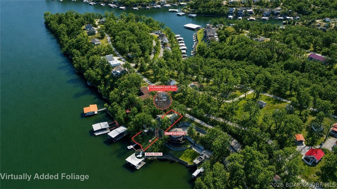 176 Kansas City Way in Sunrise Beach offers lakefront living at Lake of the Ozarks with 88 feet of waterfront, wide water views, and convenient access to Hwy 5. This 3 bedroom, 3 bath home provides approximately 2,056 square feet with a walkout lower level and outdoor spaces designed to enjoy the lake. Wake to sunrise views from the walk in primary suite, then head downstairs to the main living area where large windows frame the water and a wood burning stove adds warmth on cooler days. Additional bedrooms are located on lower levels, while a separate two room bungalow without plumbing provides bonus space. Outside, multiple decks, a hot tub, private tram, and included swim dock make lake days easy. The property is dockable and permitted for a 2 well dock with swim platform, pump, and deck, offering room to create your ideal waterfront setup. Rentals are allowed, including nightly and weekly stays, adding flexibility for a vacation home, investment property, or full time lake residence. City water, city sewer, and proximity to Sunrise Beach shopping and dining add everyday convenience. Seller is offering a $500 Achosa Home Warranty with sale.