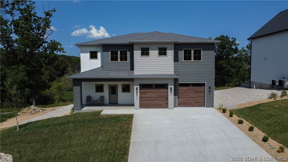 Seller Open to Trades- will get creative! Call for details. New construction with a flat driveway, beautiful lake views, lake access, and an INCLUDED 12x32 boat slip in the heart of Osage Beach at Harpers Cov! Ideally located by land and water at the Osage 19 mile marker, this desirable community offers convenient golf cart access to the docks, additional slip options, a lakeside pool, park, streetlights, community trash, and city water/sewer. Designed for modern lake living, this 4-bedroom, 3.5-bath home features two en-suite bedrooms, a spacious laundry room, and an open-concept floor plan. The primary suite includes a walk-in closet and spa-inspired bath with a luxurious wet room, soaking tub, and tiled walk-in shower. The gourmet kitchen offers high-end appliances, abundant cabinetry, and a walk-in pantry. A spacious great room with fireplace opens to an oversized deck and firepit area, perfect for entertaining. Quality craftsmanship, upscale finishes, thoughtful design, and an oversized garage complete this exceptional home—ideal for full-time living, a vacation retreat, or investment. Open for Trades, call for details. Large boat slips available.