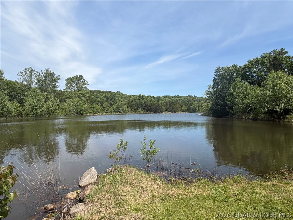 2.84 acres of gentle/flat, very buildable, lakefront land on the 28 acre interior Bob Lake at Forbes Lake of the Ozarks. Bob Lake is quiet and great for fishing and plenty of wildlife for viewing. Alternate access to Bob lake just around the corner with boat ramp and gazebo for days that demand a picnic! Not only is this land buildable, but electric and fiber optic cable (Co-Mo connect with 1 Gb/sec download speeds) have already been run, so all you need to do is bring a well and septic. Only a 25 minute Drive to Warsaw, you've got privacy, the perfect spot to camp, or build, and you are on the water for fishing in minutes.  Other amenities include baseketball/tennis courts 11 campin slips with electrical,water & picnic tables for those weekends you want friends to join you, a walking trail, 2 playgrounds and more, all within a gated community.  All while being close to the amenities of town! Speaking of amenities, Forbes Lake of the Ozarks provides a club house, tennis courts, and access to all interior lakes and the main lake to all its owners. Take a look today at this hidden gem!