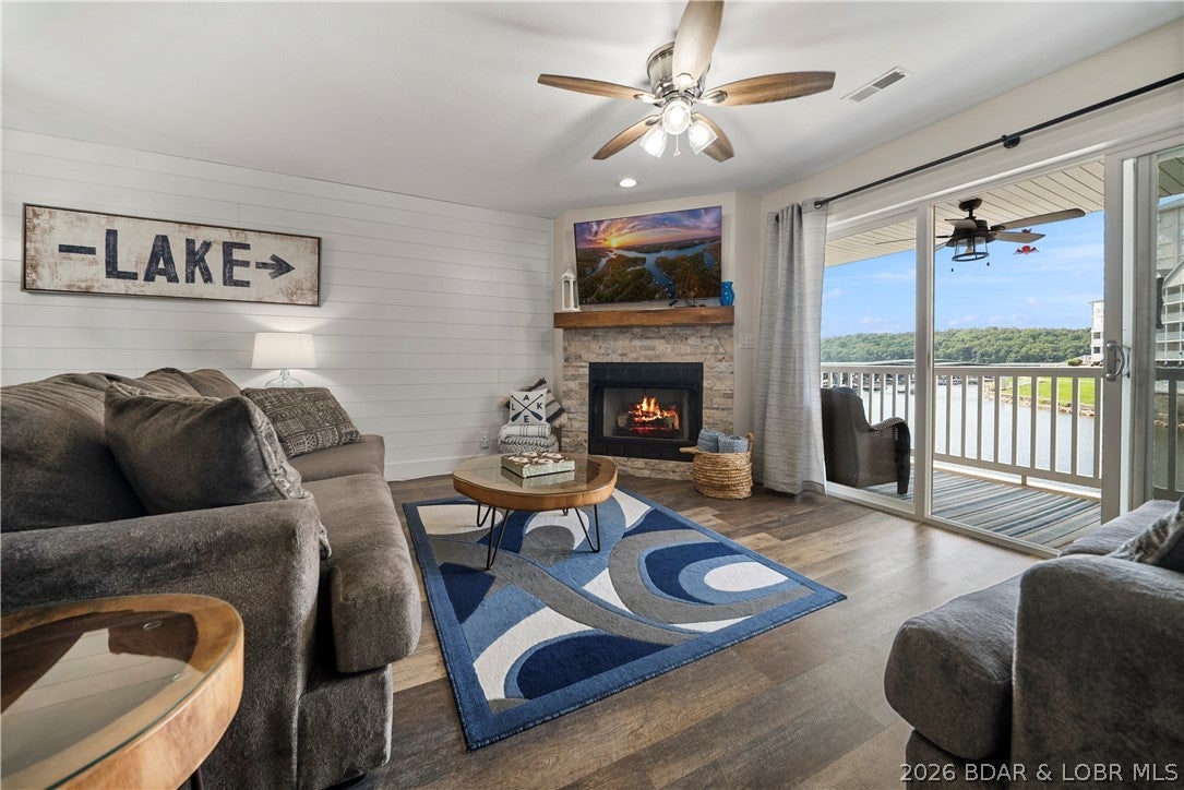 Freshly updated, fully furnished & surrounded by the natural beauty of Lake of the Ozarks State Park, this 2-bedroom, 2-bath Parkview Bay condo offers a peaceful setting without giving up convenience. Located just one level down from parking, the unit has been extensively renovated with new LVP flooring, updated fixtures, HVAC, exhaust fans & stylish finishes throughout. The inviting living area features a stone-front fireplace, shiplap accents & expansive glass doors framing serene lake and State Park views. The refreshed kitchen stands out with quartz and butcher block countertops, stainless appliances & an open connection to the dining and living spaces. The primary suite enjoys a wall of windows, large walk-in closet, double vanity & walk-in shower with rainfall shower head. Step outside to the covered concrete patio for lake breezes and an incredibly private backdrop. A 12x30 boat slip, 10,000lb BOAT LIFT, and a PWC space are included! With ample parking and easy access to popular destinations by land and water, this TURNKEY condo is ready for your next chapter at the Lake.