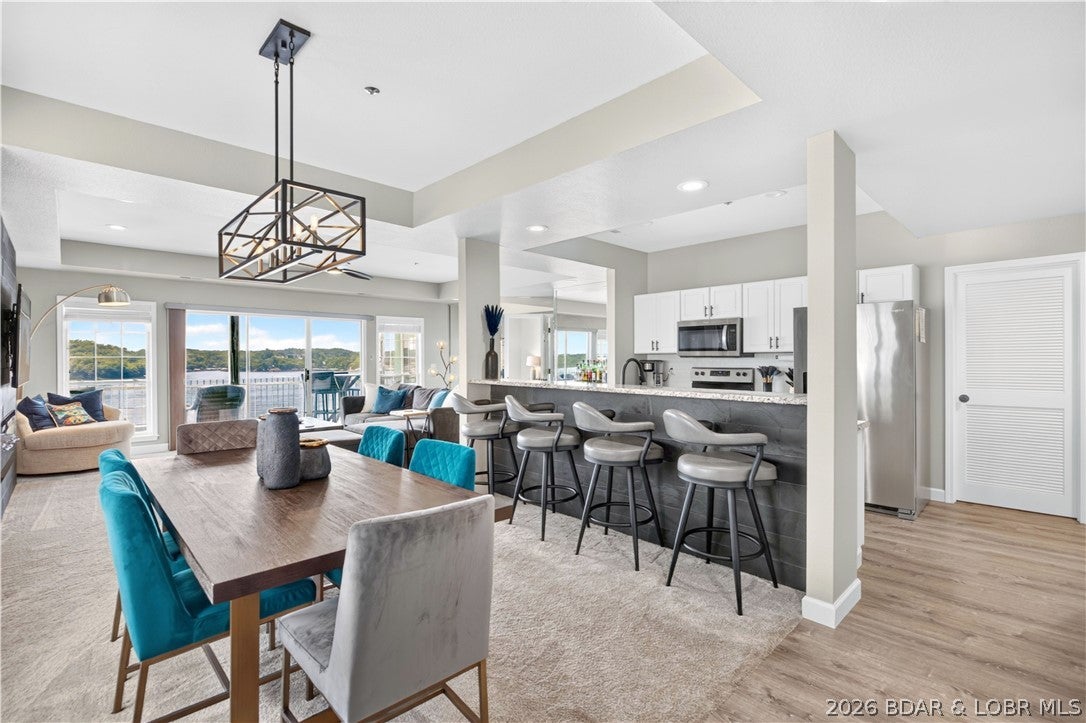 803 East Harbour Towne Drive #E-803 in Lake Ozark brings together the pieces buyers want for easy Lake of the Ozarks living. This updated 3-bedroom, 3-bath end-unit condo offers 1,520 sq ft of one-level living and comes furnished with a 14x40 boat slip with potential to expand to 16x40. The bright, open kitchen, dining and living areas flow together for effortless entertaining, while expansive windows keep the lake front and center. Step onto the covered, screened deck for morning coffee, evening cocktails or simply watching the boats go by at the 2 Mile Marker. Each bedroom has convenient access to a full bath, giving family and guests room to spread out. Harbour Towne offers community pools, clubhouse, fitness facilities, tennis courts, playground and more. Rentals are allowed, adding flexibility as a full-time home, lake getaway or investment property. A detached garage is available for an additional $30,000.