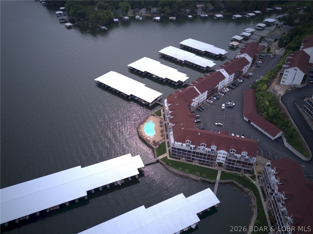 Located in the highly sought-after Clearwater Condominiums (Camdenton area) at the Lake of the Ozarks, this unique offering features two connected lakefront condos totaling 5 bedrooms and 4 full baths in one of the community’s best locations. Ground-floor living provides direct walk-out access to the lake, docks, pool, and boat slip. The 1A side has been beautifully remodeled with a brand-new kitchen, new flooring, and a renovated master bathroom. Additional upgrades include two newer high-efficiency HVAC systems. This is the ONLY condo in Clearwater connected to the adjoining unit by both an interior door and exterior deck access. Together, they create an incredible lakefront retreat with two kitchens, two living rooms, and an expanded double-sized deck—perfect for families, entertaining, or investment opportunities. The units can be separated by locking the demising doors, allowing rental flexibility.  Included is a rare 40-foot boat slip—one of only six available in Docks A–H, plus a double Sea-Doo slip with 600-1B. Large slips like this are nearly impossible to find at Clearwater. Enjoy the outstanding amenities Clearwater Condominiums offers.