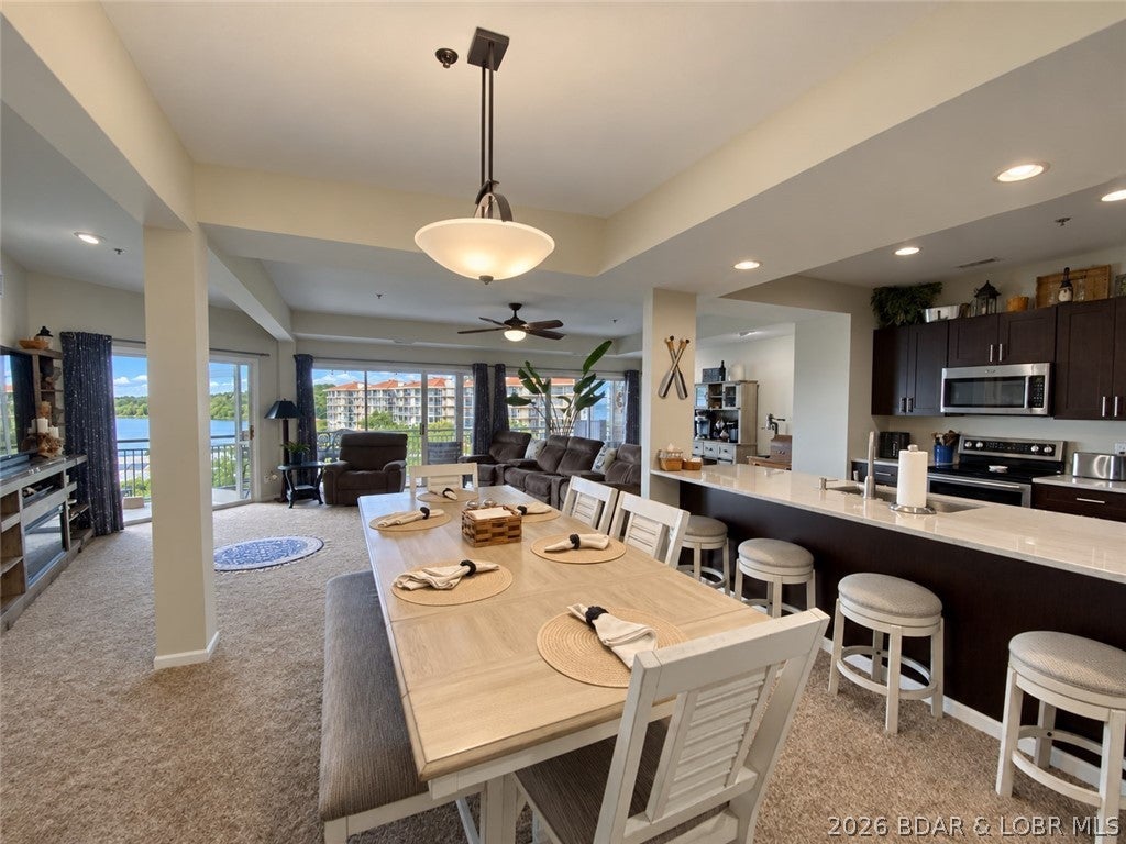 SUNSET VIEWS, SPACIOUS LIVING AND THE COMPLETE LAKE PACKAGE! This beautifully remodeled 3-bedroom, 3-bath waterfront condo offers 1,710 sq. ft. in one of only six units at Palisades with this unique, larger layout. Each bedroom is paired with a full bath, offering comfort and privacy for family and guests. Three large lakefront sliders fill the open living area with natural light while showcasing the gorgeous views. The remodeled kitchen features custom cabinetry, quartz countertops, stainless appliances and an oversized island made for gathering and entertaining. The lakefront primary suite has a remodeled bath and private slider to the oversized screened deck, where three ceiling fans and spectacular west-facing sunset views create the perfect place to relax. Only 12 steps lead to the front door, and the dock is conveniently located just outside. A 12x32 boat slip, assigned parking and private garage with electricity, opener and overhead storage are included. A 6,500-lb boat hoist is available for additional money. Perfectly positioned at the 14 Mile Marker on prestigious Horseshoe Bend, Palisades offers three pools, a waterfront boardwalk, clubhouse, pet areas & gated entry.
