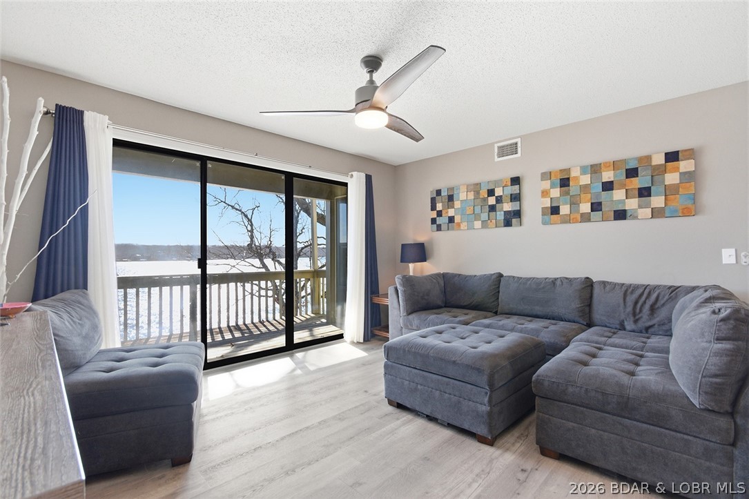 Here is an opportunity to purchase an impeccably maintained and fully furnished 2 bedroom,2 bath, end unit at Pelican Bay Condominiums. This is a walk in level unit with a "Handicap Accessible" ramp. Located at the 26 mm next to Margaritaville, this unit boasts spectacular views of the Main Channel. Unit has newer LVP Flooring, appliances, and recent paint making this unit ready for you to start enjoying immediatley. Outside, the pool and hot tub is just a short walk away with a clubhouse that lends itself well for gatherings such as family reunions or birthday parties. The unit comes with a 24 ft. boat slip and a less than 2 year old 6000# lift. Also available for purchase is a 2008 Famouscraft 24 ft. Deck Boat. This is a highly desireable location here at the lake by land or water, and would make an excellent rental unit. Come check out this unit and see what Pelican Bay has to offer.
