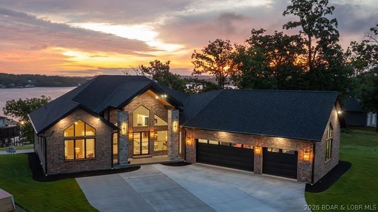 Where LAKE LIVING meets LASTING LUXURY. Sweeping panoramic views of MM19 frame this stunning 2025 new-construction masterpiece — 6,600 SF, 4BR/4.5BA, with 3,300 SF of stair-free main-level living. Built to a standard the market hasn't seen, every detail is by design: Marvin doors and windows throughout, custom Bevolo lighting, true 400-amp electrical service, 26KW whole-house generator, R-38+ spray foam insulation, a 40×30 heated and cooled garage with 16-ft ceilings, and a CertainTeed 50-year wind-rated roof. The SubZero/Wolf/Cove kitchen with 5×10 Cambria quartz island, 62,000 BTU gas fireplace, and lakeside wrap deck were crafted for effortless entertaining — and this is just a taste. Enjoy the view and lake access without the hassle: no flood insurance, no dock maintenance, two marinas within walking distance, with boat slip lease available. Ideally situated near the hospital, dining, and all Osage Beach amenities, with city water, sewer, and natural gas. A comprehensive features list is attached, but no document can prepare you for the experience of walking through this home. The description will tempt you — the home will convince you.