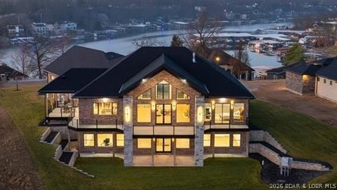 Where LAKE LIVING meets LASTING LUXURY. Sweeping panoramic views of MM19 frame this stunning 2025 new-construction masterpiece — 6,600 SF, 4BR/4.5BA, with 3,300 SF of stair-free main-level living. Built to a standard the market hasn't seen, every detail is by design: Marvin doors and windows throughout, custom Bevolo lighting, true 400-amp electrical service, 26KW whole-house generator, R-38+ spray foam insulation, a 40×30 heated and cooled garage with 16-ft ceilings, and a CertainTeed 50-year wind-rated roof. The SubZero/Wolf/Cove kitchen with 5×10 Cambria quartz island, 62,000 BTU gas fireplace, and lakeside wrap deck were crafted for effortless entertaining — and this is just a taste. Enjoy the view and lake access without the hassle: no flood insurance, no dock maintenance, two marinas within walking distance, with boat slip lease available. Ideally situated near the hospital, dining, and all Osage Beach amenities, with city water, sewer, and natural gas. A comprehensive features list is attached, but no document can prepare you for the experience of walking through this home. The description will tempt you — the home will convince you.