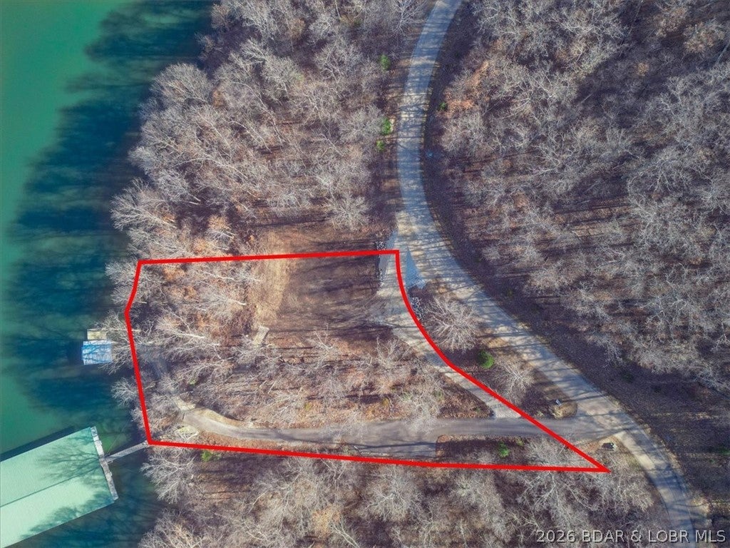 Prime 1.3-acre lakefront opportunity in prestigious Eagle Bay! This ready-to-build lot offers 226' of shoreline at the peaceful 55MM in Gravois Mills, combining privacy with quick access to waterfront restaurants, marinas, and town amenities. Professionally cleared and prepared for construction, this exceptional property is the perfect setting for your custom lakefront home or luxury retreat. Enjoy immediate access to the water with an existing wood dock featuring a 10x24 boat slip. Utilities are already available, including electric, water, sewer, and fiber internet, saving time and expense as you build. The gentle terrain and expansive 1.3-acre footprint provide endless possibilities for outdoor living, entertaining, and maximizing breathtaking lake views. Located in one of the Lake of the Ozarks' most desirable communities, this property offers the ideal blend of convenience, tranquility, and investment potential. Don't miss this rare chance to build exactly what you've envisioned. Schedule your private tour today and start living the lake lifestyle you've always wanted! Build now and enjoy lake life with space to create the custom retreat you've always imagined! Call now today!
