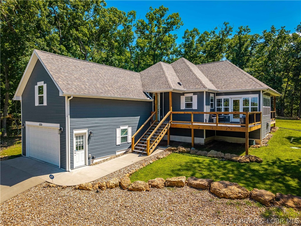 72 Hour Kick-out! Nestled among the trees in the highly sought-after Four Seasons subdivision, this beautifully maintained 3-bedroom,2-bathroom home offers serene lake views, abundant wildlife, & total peace & privacy—complete with an *extra lot* for added space or future potential.With 1,940 sq ft of thoughtfully designed living space, you’ll love the tall ceilings, natural light pouring in through the expansive sunroom windows,& a seamless flow throughout the home.The kitchen is a chef’s dream w/stainless steel appliances, a gas stove,beverage/wine cooler,& plenty of counter space for entertaining.Step outside to enjoy the fresh air from either your covered patio or the open patio—perfect spots to soak in the seasonal lake views.The oversized 2-car garage offers additional storage, and there's an insulated, carpeted bonus space under the home ideal for paddleboards, outdoor gear, or a small workshop.Additional highlights include a tankless water heater,new state-of-the-art indoor aquatic facility just minutes away,& access to all the Four Seasons amenities. This home has it all—space, comfort, and that peaceful Lake Ozark lifestyle. Lot to the right of the home is included.