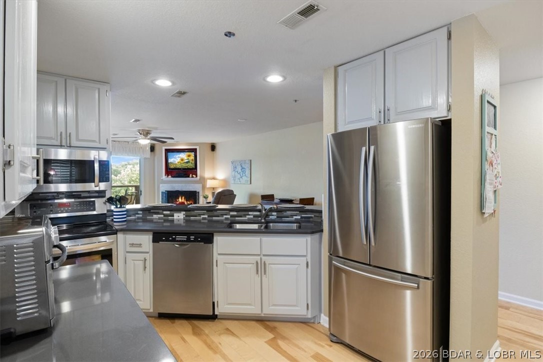 Seller offering a $5,000 towards closing costs or HOA Fees & 1 year home warranty! Step into the ultimate lakeside haven with this accessible, no-steps 3-bed, 2-bath condo, boasting breathtaking, mile-long views. Perched in the coveted State Park area, it's just minutes from vibrant shopping and dining, making every adventure—from a serene sunset cruise to a lakeside dinner or a full day on the water—easily within reach. This prime location ensures you're always at the heart of the action. Fully furnished and completely move-in ready, this condo is crafted for maximum convenience, allowing you to dive straight into the lake life without any hassle. The open floor plan and end-unit layout flood the space with natural light, creating a warm and welcoming atmosphere. Relax on your private balcony, soaking in the stunning vistas that stretch as far as the eye can see. Boating lovers will be thrilled with the included 12x30 boat slip featuring a 4,000 lb hoist & a PWC slip just steps away When you're ready to unwind on land, take advantage of the impressive amenities, including pool, clubhouse, exercise room, playground, and a cozy fire pit.