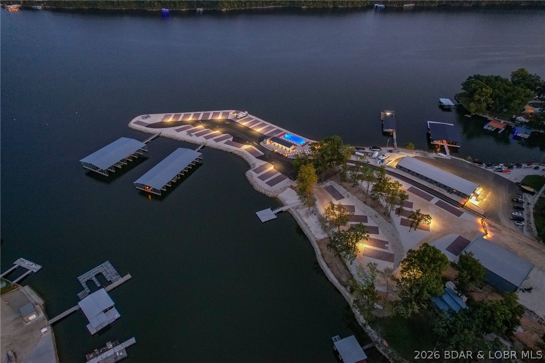 Welcome to Paradise Point RV Resort—one of the most exciting opportunities to own at the 38MM of Lake of the Ozarks. Set on a stunning peninsula with incredible panoramic views, this development offers both lakefront & second-tier RV lots now available for individual purchase. Every site is built right—level concrete pads with full hookups including 100-amp electric, water, sewer, and Wi-Fi—designed for comfort, convenience, & long-term value. An HOA ($200/month) keeps the community maintained and looking sharp. The amenities set this apart: lakefront pool, sandy beach, swimming dock, marina with boat slips available, covered pavilion with grills, large stone fire pits, bathhouse with laundry, and fenced dog park. Whether you want to relax or entertain, it’s all here. Leave your RV on-site year-round and skip the hassle of hauling. When you’re not using it, rent it out for additional income—strong demand makes this a smart investment as well as a lifestyle play. Located in Sunrise Beach with easy access by land and water, this is lake living without the typical price tag or maintenance. Multiple lots available with varying prices—secure your spot now before they’re gone.