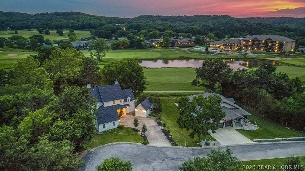You’ll be captivated by the custom craftsmanship & elegant design of this exceptional home, perfectly situated at the end of a wooded cul-de-sac along the 18th fairway of the renowned Tom Weiskopf-designed golf course in Old Kinderhook. This home is a show stopper and is ready for you to move right in! As soon as you walk inside, you will be greeted by soaring 30-foot ceilings & updates throughout this beautiful home. The main level features a pristine kitchen with pantry, an elegant dining room, and a flexible office or guest bedroom, while wraparound decking overlooks the course. The upstairs features the master bedroom with high ceilings, an oversized master bath & private porch. Down the hall, you will find another ensuite. Downstairs, the home continues to impress w/ a spacious family room, game area, Ensuite, another bedroom, & a storm shelter/storage. This home is walking distance to the resort’s year-round amenities—including 4 pools, spa, tennis, fitness centers, on-site dining, & the magical Christmas Village. The home has plenty of parking and a 3-car garage. Your new lake lifestyle begins here—don’t miss the opportunity to make this stunning property yours.