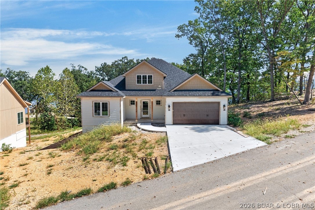 Welcome to Diamond Crest Estates new construction, second tier with phenomenal Lake of the Ozarks views. Located at the 45 mile marker just off Highway 7, this stunning second-tier home offers phenomenal lake views and an ideal location for enjoying the lake lifestyle. Just over 3,200 sqft, this two story home features a spacious upper level that is finished and ready to enjoy, along with a lower level that is framed and ready to be completed to suit your vision. Whether you envision additional bedrooms, a home theater, game room or expansive entertainment space, the possibilities are yours to create. A two car garage provides ample storage for vehicles and lake toys, while the elevated setting captures beautiful lake views from the home. The home offers a rare opportunity to own a brand new home while adding your own personal touch. Come see the possibilities and make this Lake of the Ozarks retreat your own!