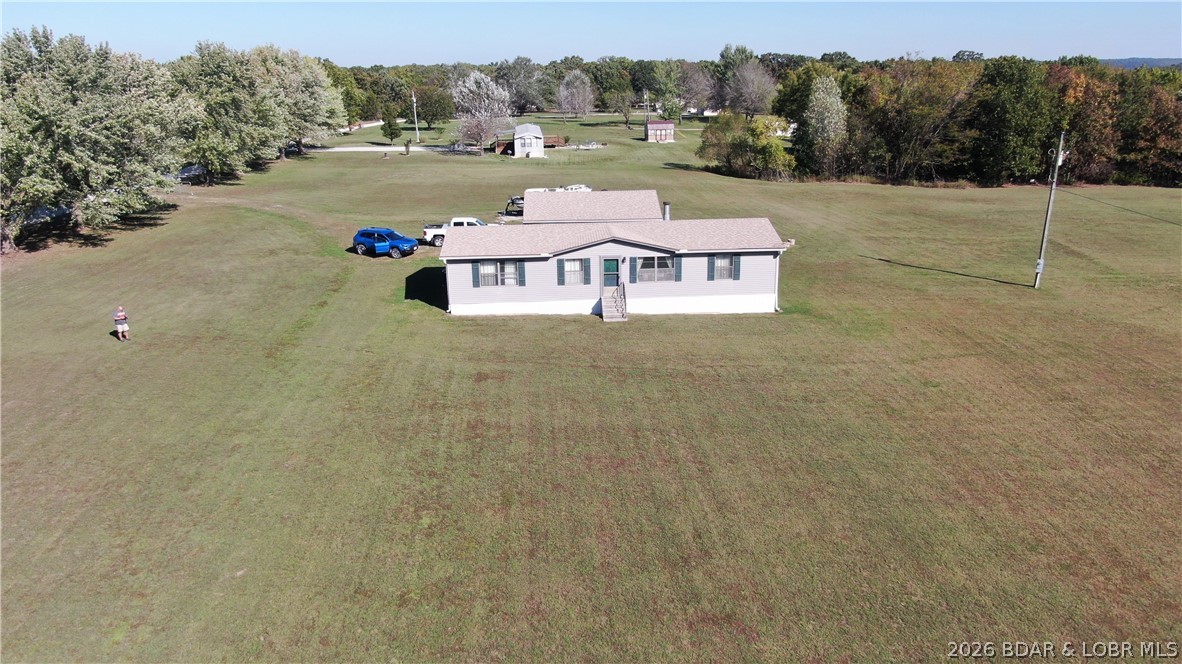 **Country Retreat Near Truman Lake a Great Opportunity for a Possible Hobby Farm.   **

Nestled on approximately 6± acres, this 3-bedroom, 2-bath manufactured home offers peaceful country living just 5 minutes from French Bridge Access at Truman Lake. Enjoy cozy evenings by the wood-burning fireplace, a spacious 2-car detached garage, partial pond access, and a property fenced on three sides.

Previously enjoyed as a family fishing cabin, this versatile property would make an excellent full-time residence, weekend getaway, or hobby farm. Conservation land within walking distance provides additional opportunities for hunting, hiking, and wildlife viewing.

The home is in nice condition and offers great potential for cosmetic updates and personal touches. Property is being sold AS IS.