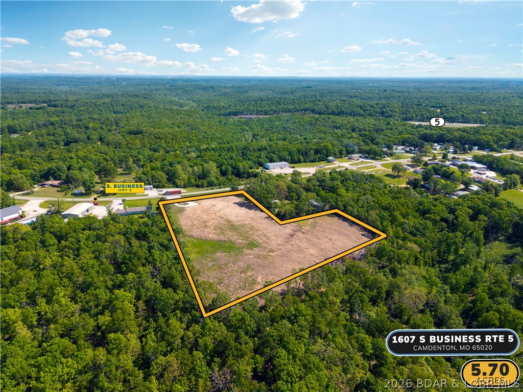 Nearly 6 acres of versatile, level ground with 250 feet of highway frontage on S Business Route 5 — one of the most accessible and visible development corridors in Camden County. Located just 2 miles from the Camdenton square and less than half a mile to the new Highway 5 interchange, this 5.7-acre B2 General Commercial tract offers a rare combination of size, location, and flexibility that is simply hard to find in this market. Suitable for commercial development, multi-family housing, mixed use, storage, or a private campus-style build, the property offers dual access and a level footprint ready for your vision. Seller is open to redivide, build-to-suit arrangements, and creative structuring — making this as flexible as it is rare.