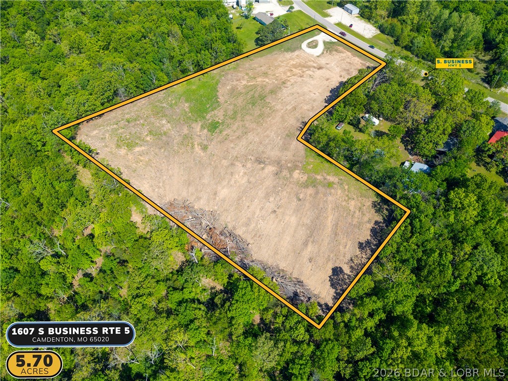 Nearly 6 acres of versatile, level ground with 250 feet of highway frontage on S Business Route 5 — one of the most accessible and visible development corridors in Camden County. Located just 2 miles from the Camdenton square and less than half a mile to the new Highway 5 interchange, this 5.7-acre B2 General Commercial tract offers a rare combination of size, location, and flexibility that is simply hard to find in this market. Suitable for commercial development, multi-family housing, mixed use, storage, or a private campus-style build, the property offers dual access and a level footprint ready for your vision. Seller is open to redivide, build-to-suit arrangements, and creative structuring — making this as flexible as it is rare.