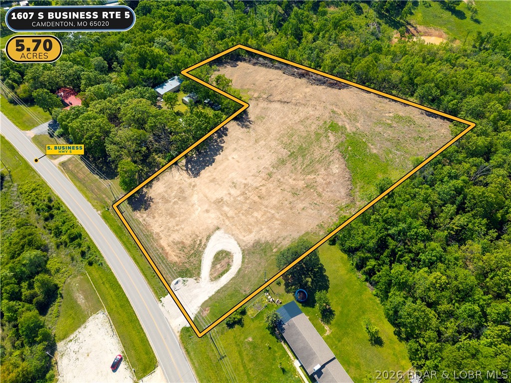 Nearly 6 acres of versatile, level ground with 250 feet of highway frontage on S Business Route 5 — one of the most accessible and visible development corridors in Camden County. Located just 2 miles from the Camdenton square and less than half a mile to the new Highway 5 interchange, this 5.7-acre B2 General Commercial tract offers a rare combination of size, location, and flexibility that is simply hard to find in this market. Suitable for commercial development, multi-family housing, mixed use, storage, or a private campus-style build, the property offers dual access and a level footprint ready for your vision. Seller is open to redivide, build-to-suit arrangements, and creative structuring — making this as flexible as it is rare.