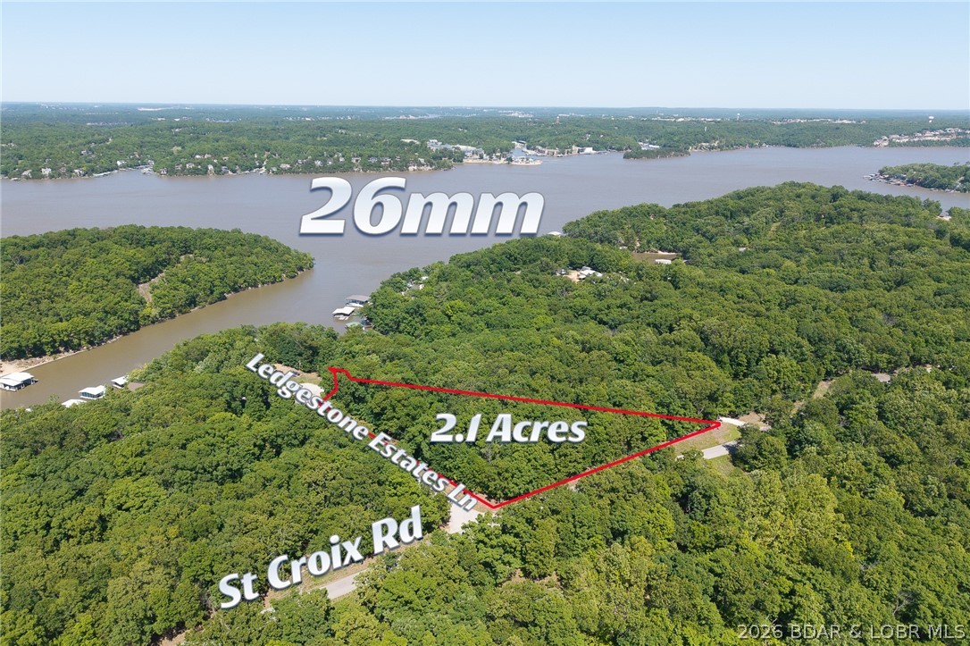 Exceptional opportunity to own one of the most impressive buildable lakeview tracts to hit the market in quite some time! This premier corner parcel offers approximately 2.1 acres at the corner of St Croix Rd and Ledgestone Estates Ln, with blacktop access directly to your future driveway. With selective clearing, the property is positioned to capture outstanding lake views and create an incredible setting for your dream home or investment property. Located in the highly desirable F-Road area of Sunrise Beach, you’ll enjoy quick access to Woods Grocery/gas station, numerous waterfront restaurants, and convenient travel to both Lake Ozark and Osage Beach. Quality buildable acreage with lake views is becoming increasingly difficult to find, making this an exceptional opportunity. Additional acreage is available directly across both roads, offering the potential to assemble up to approximately 60 contiguous acres for future development, expansion, or investment purposes. Don’t miss your chance to secure this rare piece of Lake of the Ozarks property!