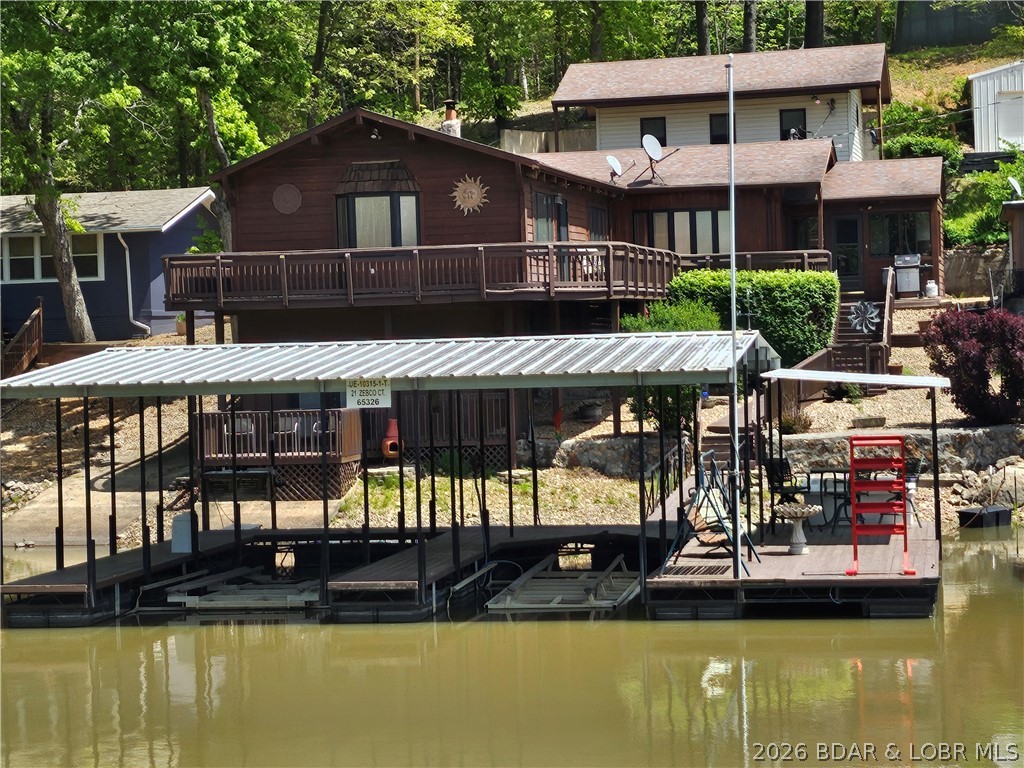 Lakefront living with private dock & lake views! Enjoy the lakefront lifestyle you've been looking for. Located across from Brown Bend Public Access, this spacious property offers excellent fishing, boating & water recreation from your dock. The main level features a large living area (extra sleeping space) with vaulted ceilings, skylights, a pellet fireplace insert. Open-concept kitchen includes an island with pull-out drawers, ample counter space, a pantry and dining area with beautiful lake views. The oversized primary suite offers abundant closet space, a full bath, and sliding doors leading to the lakeside deck. A guest bath and laundry room complete the main level. A spiral staircase leads to the lower level with a spacious second bedroom, full bath, private deck access, A workshop is ideal for hobbies or storage. Outside, enjoy multiple decks, a private dock with two slips, two boat lifts, included dock furniture, and updated electrical up to code. Fully furnished and move-in ready, this property includes a detached one-car garage with utility sink, refrigerator/freezer, and storage. Perfect as a full-time residence, weekend retreat, or short-term rental.