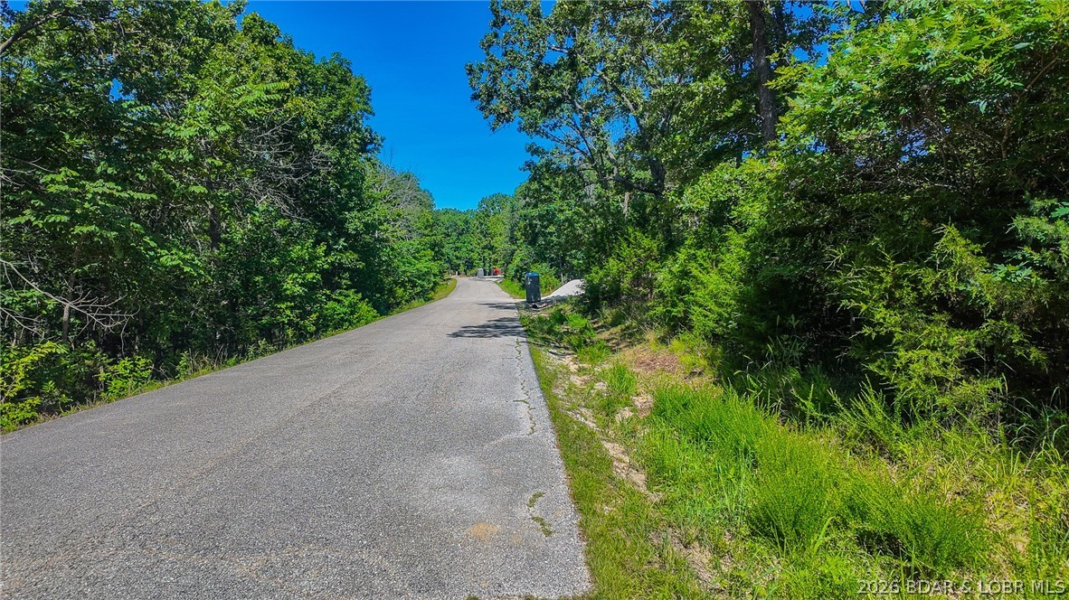 Build your dream home on Champion Drive! Discover the perfect canvas for your custom home on this beautiful, level 0.42-acre wooded lot. Offering an ideal blend of natural privacy and premium resort-style living, owners here gain access to incredible Four Seasons amenities, including multiple community pools, a fully equipped exercise room, playgrounds, and more. Building is a breeze with water and sewer agreements already firmly in place; best of all, the utility lines run directly on the same side of the road as the lot, significantly reducing your connection and installation costs. The exceptionally level topography minimizes site prep work while maximizing your usable yard space. Located in a well-maintained neighborhood with an HOA ensuring community standards, the minimum build requirement is a comfortable 1,100 square feet (or consistent with surrounding homes), perfectly protecting your long-term property value. Don't miss this rare, builder-friendly gem on Champion Drive—schedule your walkthrough today!