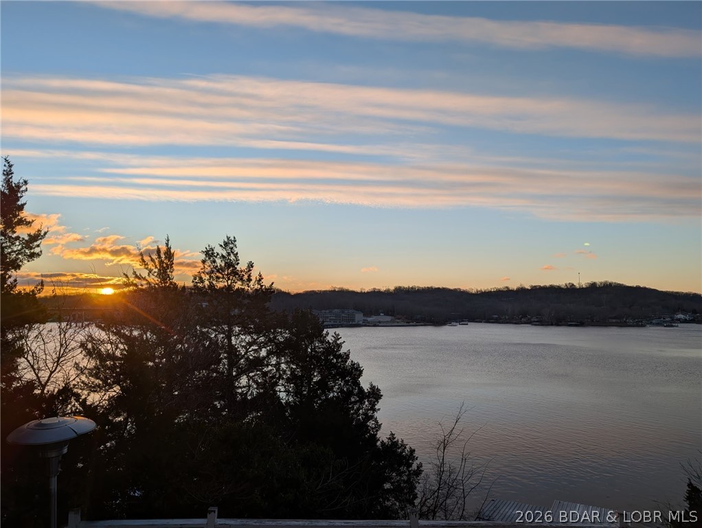 Great Lake View and nice open Decks with a Hot Tub!  Vaulted Ceiling, Wood Stove and open Living/Kitchen/Dining with Laminate Flooring and new Sliders to the Deck.  Most Furniture is staying.  Kitchen has new Stainless Steel Appliances, new Cabinets, Corian Counters and Pantry.  Master Bedroom/Bath has Walk-In Shower and 2nd Bathroom has a Walk-In Shower.  Furnace, Mini-Split, A/C Unit & Hot Tub are Wi-Fi controlled.  Included is a 2-well Dock with a Boat Lift and Jet Ski Lift.  There is a nice 2025 "Tuff Stuff" Storage Shed, Carport and level Parking.  Paved Roads and a great location on the Big Niangua with amazing Sunrises & Sunsets.