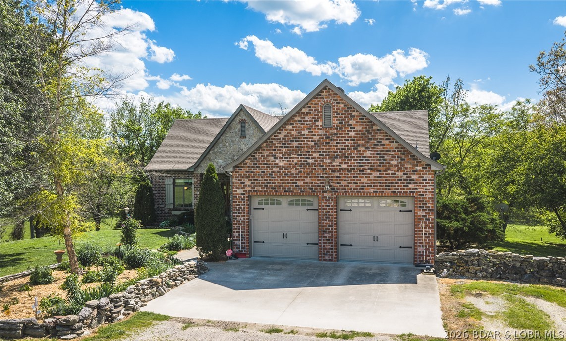 This exceptional country estate offers luxury, privacy, and functionality in a breathtaking setting. This custom-built home spans more than 3,800 square feet and showcases timeless craftsmanship with beautiful oak floors, quartz countertops, rich knotty alder cabinetry and trim, a cozy gas fireplace, and a roof updated just 4 years ago. The home features 2 spacious bedrooms, 1 non-conforming bedroom, 3 full bathrooms, and 1 half bath, providing plenty of space for family and guests. Expansive decks and a custom firepit overlook private panoramic views of abundant wildlife, peaceful creek bottoms, and rolling countryside in a truly park-like setting. Additional improvements include a 2,200-square-foot shop with a 1-bedroom, 1-bath apartment—ideal for guests, rental income, or caretaker quarters—and a well-built kennel with concrete floors. With beautiful creeks, a private driveway, blacktop access, and a prime location near Lake of the Ozarks and Springfield, this rare property truly has it all.