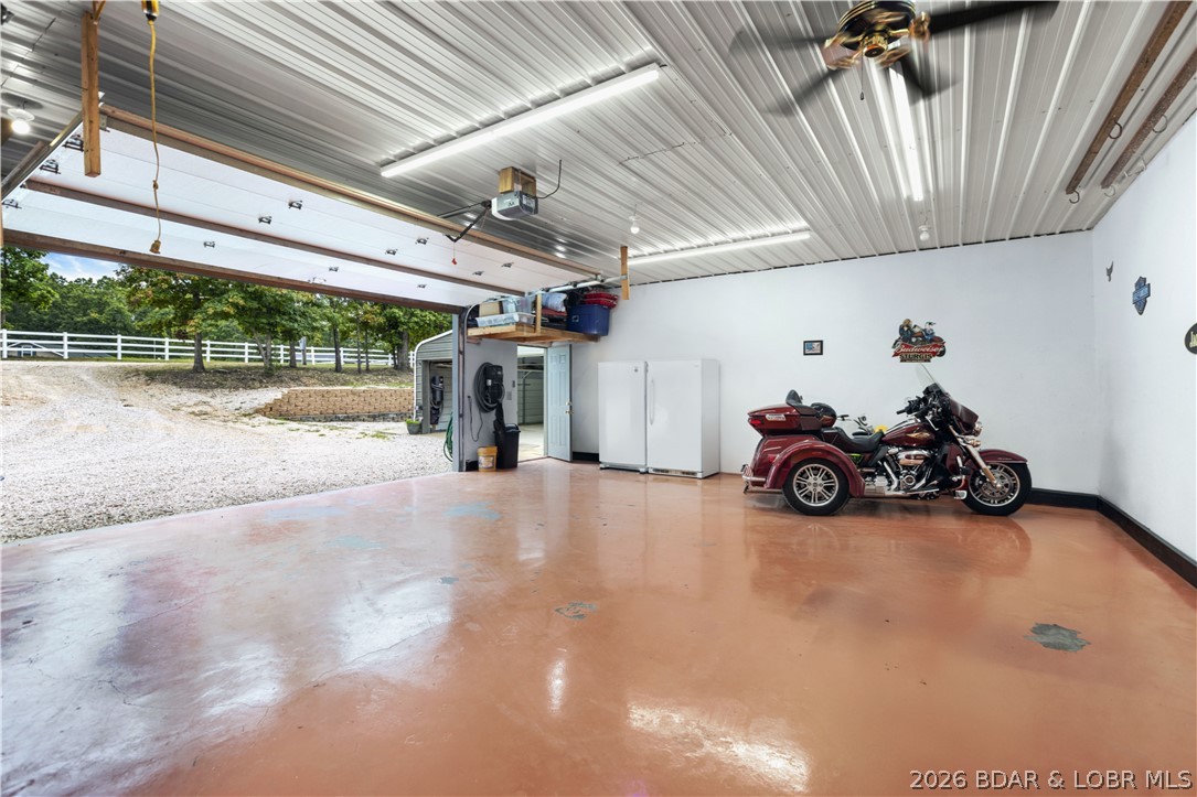 411 Valley Spring Rd in Camdenton offers a relaxed lake-area lifestyle with space to spread out and room to enjoy. Set on approximately 2.25 acres, this 3-bedroom, 2-bath home features comfortable main-level living, a welcoming living area, and a functional kitchen designed for everyday ease. The large screened-in deck overlooks the backyard, while the open deck creates a great entertainment area perfect for gatherings, outdoor dining, and future possibilities like adding a pool or trampoline.

A standout feature is the detached garage with shop space and an apartment, ideal for guests, extended family, hobbies, or rental income. An RV hookup adds even more flexibility for travelers or visiting guests. With ample parking, a carport, and a private setting surrounded by mature trees, this property offers both privacy and functionality. Conveniently located just minutes from Lake of the Ozarks marinas, dining, and local attractions, this property delivers comfort, versatility, and the opportunity to enjoy Missouri living.