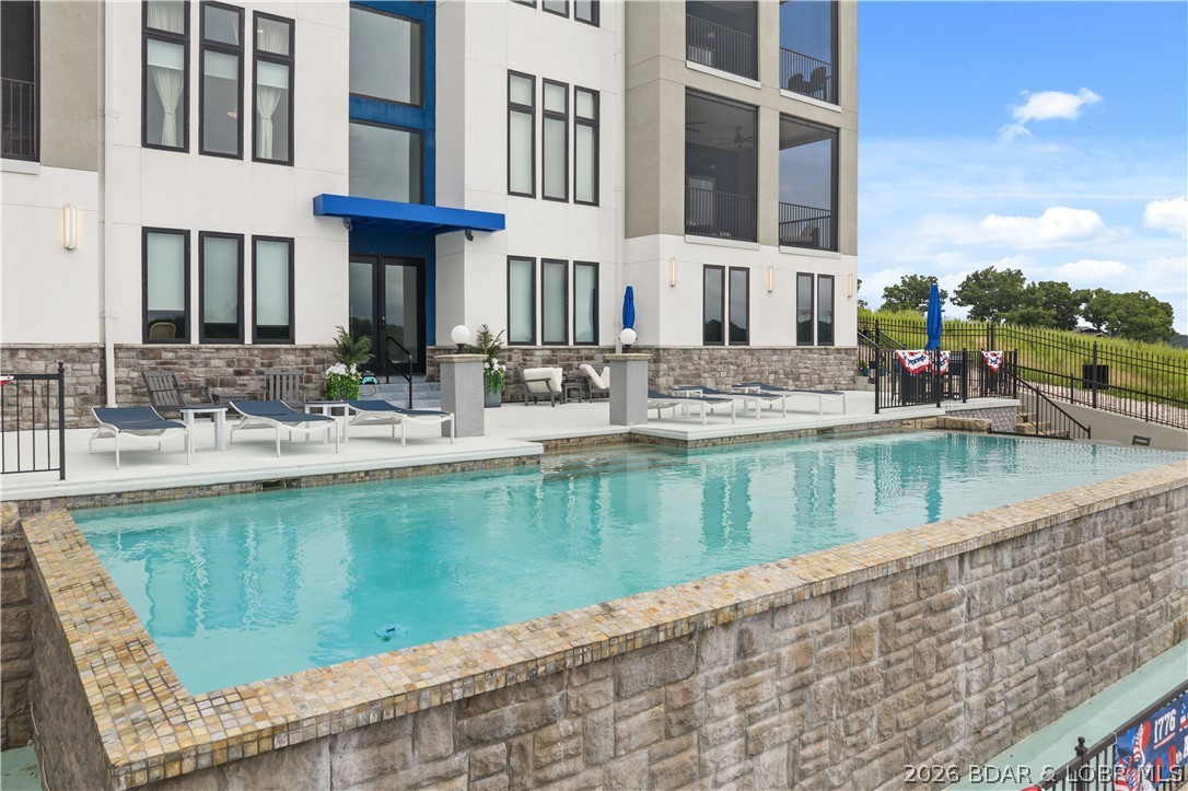 Welcome to the Exclusive Shores of Shawnee Bend, the Epitome of Luxury Living at Lake of the Ozarks! Nestled in this private oasis complex are only 6 units. Rentals are not allowed ensuring that each moment spent here is exclusively yours - free from crowds or disruptions. Available now is this Breathtaking First Class 3-bedroom, 3.5-bath condo on MM18 in Sunrise Beach boasting extraordinary craftsmanship & meticulous attention to detail showing off elegance & sophistication. Key Features include Gourmet Kitchen (Gas cooktop, ZLine appliances, XL Island, Honed Granite, Pantry), Open Floorplan, All Bedrooms are Large En-Suites w/Grand Bathrooms, High Ceilings, Turnkey, Garage, 12x32 Boat Slip with 7,500lb, PWC Slip, Huge Tiled Covered Private Balcony overlooking the Sparkling Pool & Captivating Main Channel Views, Gated Community, Elevator (no steps!), 9 minutes from Lake Ozark and SO MUCH MORE!!!! Tailored amenities include an infinity swimming pool, hot tub, public fire pit, & outdoor master grill. Come See This Beauty TODAY & Make this Your Piece of Paradise! Check out the Virtual Tour!