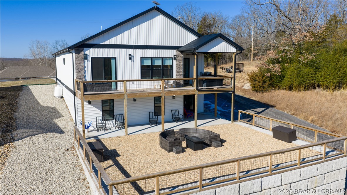 Calling all investors! This newly constructed 4BR, 3BA lake-view home offers exceptional income potential and flexibility. Located within the state park and including a 12x30 boat slip, the property is perfectly suited for vacation rentals, long-term rentals, or owner-occupants looking to offset expenses. The unique layout allows the home to function as one large rental or potentially accommodate two separate rental opportunities, with a full kitchen, living space, laundry, and bedrooms on both levels. The upper level features an open-concept design, luxury finishes, a stunning primary suite with deck access, granite countertops, remote blinds, LVP flooring, and marble tile baths. The lower level includes 2 bedrooms, 1 bath, a second kitchen, living/game area, and second laundry. Separate lower-level access and side parking provide added convenience while expanding the possibilities for how the home can be used. Whether you're looking for a smart investment, a personal lake retreat, or a property that can help pay for itself, this flexible lake-view home offers opportunities that are hard to find in today's market. Watch the video and schedule your private showing today!