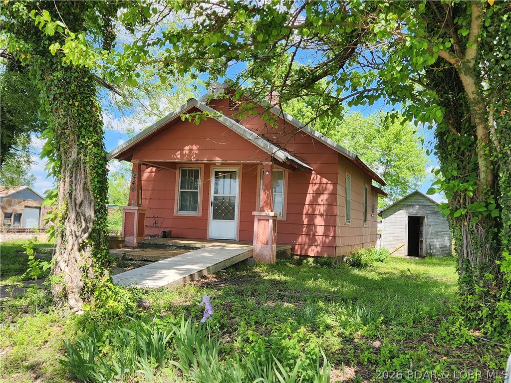 This small home on a rather large lot is right in the middle of the sweet little town of Stoutland Missouri. It's walkable to gas station/restaurant/downtown. There are two bedrooms and 1 bath, and it's never been empty long. Recently it's been a rental, and it could use some TLC, but it's got a newer metal roof, two outbuildings, and a large shady yard plus off-street parking. There's inside laundry too on the enclosed back porch.