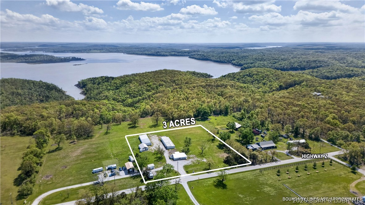Newly remodeled 2-bedroom home on 3± acres offering views of Truman Lake! This property features a spacious living room filled with natural light, two large bedrooms, and a versatile third room that can serve as an office or non-conforming bedroom. Durable metal siding and a metal roof provide low-maintenance living and long-term peace of mind. Formerly part of the Z Highway RV Park, the property also includes 16 storage units and a bonus building with excellent potential for additional income or guest accommodations. Conveniently located just 15 minutes from Warsaw and 25 minutes from Clinton, this property combines scenic lake views with investment opportunity and easy access to nearby amenities.