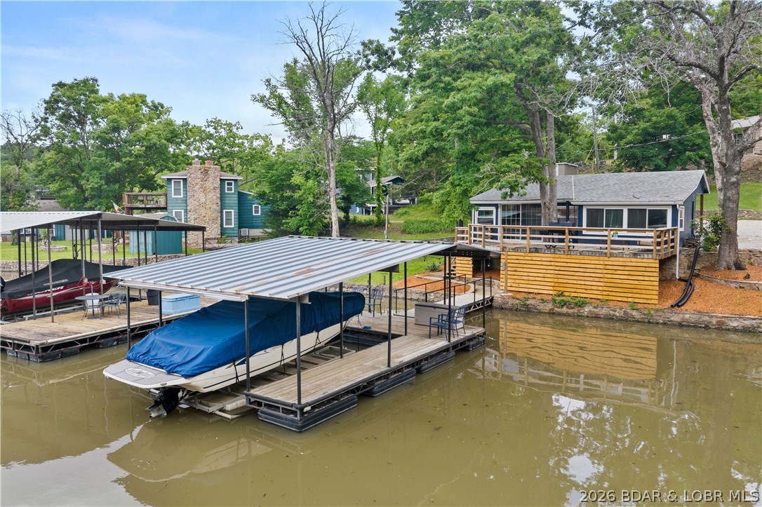 Experience premier lakefront living at its finest in Sunrise Beach, MO! This charming, recently updated cabin is perfectly tucked
into a serene, deep-water, no-wake cove near the iconic Hurricane Deck Bridge at the 35 MM, offering the ultimate blend of privacy and convenience. Inside, sophistication meets comfort with fresh flooring throughout, new interior and exterior paint, brand-new countertops, a new dishwasher, beautifully renovated bathrooms, highly efficient new mini-split systems providing year-round
comfort, and a brand-new septic system for total peace of mind. Step outside to enjoy your private dock boasting year-round deep water, making it absolutely ideal for swimming, boating, and lakeside relaxation. Location is everything; you are just minutes from popular restaurants, entertainment, and gas stations—seamlessly accessible by land or water in any direction. This turnkey
home comes fully furnished, and nightly rentals are permitted, offering incredible versatility. Whether you seek a weekend retreat, a full-time lake residence, or a lucrative investment property, this turnkey gem checks every single box. Call today to schedule your private showing!