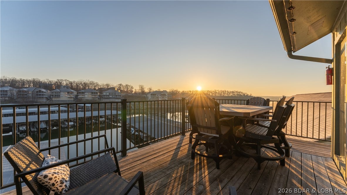Rare opportunity to own a fully updated, turnkey lakefront condo at Southwood Shores! This 2-bedroom, 2-bath top-floor unit sits at the 12 Mile Marker in Lake Ozark and combines an incredible location, beautiful views, amenities, and proven rental potential. Step inside to a bright, stylish interior featuring vaulted ceilings, beautiful flooring, and a fully updated kitchen with white cabinetry, stainless appliances, and plenty of countertop seating. The thoughtful interior design gives the entire condo a clean, modern lake feel and it comes fully furnished and ready to enjoy. Step outside onto the huge deck for incredible lake views and plenty of room to relax or entertain. You're just steps from the pool, while Southwood Shores offers indoor and outdoor pools, a hot tub, clubhouse, playground, boat ramp, and gated entry. The indoor pool adds to the year-round rental appeal, and this unit already has a great rental history with nightly rentals allowed. A 10x24 boat slip with lift is included, making this the complete Lake of the Ozarks package!