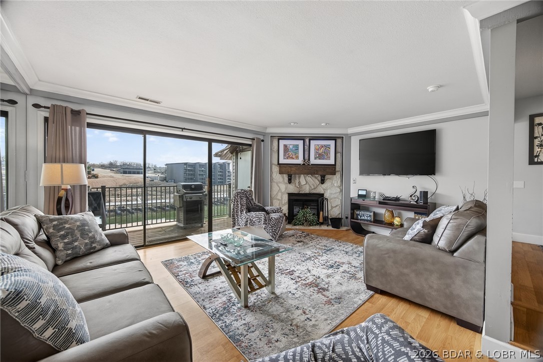Top-floor views and lake life at its best. This 2 bedroom, 2 bath condo in a highly sought after complex is all about easy living and effortless entertaining. Wall-to-wall lakeside sliders keep those breathtaking views front and center all day long and also provide an abundance of natural light. The open layout flows perfectly, featuring a kitchen with breakfast bar and dining area, while the cozy fireplace adds warmth and charm to the living space. Partially furnished. The large lakeside deck is perfect for morning coffee or evening BBQs. 10x24 slip is included, just bring your boat and start enjoying the lake life. Enjoy numerous on-site amenities including a pool, clubhouse, management, security, playground, boat ramps, tennis/pickleball courts, fitness area, waterfront walking/golf cart path, firepit area, and multiple scenic, waterfront viewing areas. Conveniently located by both land and water, this is more than just a complex, it’s a true lakefront community.
