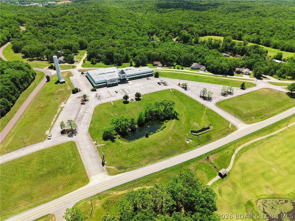Rare commercial opportunity in the heart of Laurie. With 10.68 acres, approximately 27,662 square feet, and 1,200 feet of frontage on Hwy O, across from the golf course, this prominent property delivers the visibility, access, and scale investors look for. Anchored by a well-established 5-screen cinema, the site also features multiple retail spaces, a restaurant location, and a standalone ATM tenant. Level ground, multiple pad sites for expansion, 100+ parking spaces, city sewer, electric, Co-Mo fiber optic internet, and city water coming in April 2026 add to the appeal. Seller will provide a 5-year lease for the cinema at closing, offering built-in income potential. Cinema business and equipment are not included.