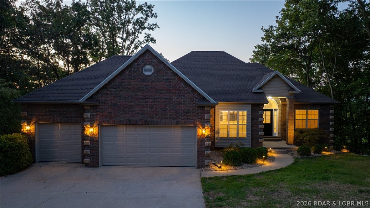 Completely remodeled Golf Course home with Four Seasons amenities (indoor pool, boat ramps, and more)! A perfect family retreat or vacation rental. Every detail has been updated: carpet was replaced throughout with durable LVP flooring, fresh paint, new fixtures, and fully renovated bathrooms. The primary suite features a spa-like walk-in tiled shower, a new second closet, and an updated closet system. The second bath is entirely new, from vanity to shower enclosure to flooring. The lower level was expanded to enlarge the spacious second living area, and added a new half bath. There are two additional bedrooms on lower level, and a fully redone third full bath. A large storage/utility room offers bonus flexibility — ideal as a workshop. Step out from the lower living area to a newly landscaped backyard with lighting and a firepit, perfect for cool evenings. The oversized 3-car garage includes an extended third bay, great for a golf simulator or shop space. New roof, newer water heater, and newer HVAC provide peace of mind. Great location on the 8th hole at The Ridge Golf Course at Top of Horseshoe Bend, so you'll miss all the HH traffic, and just minutes from the Famous Strip!