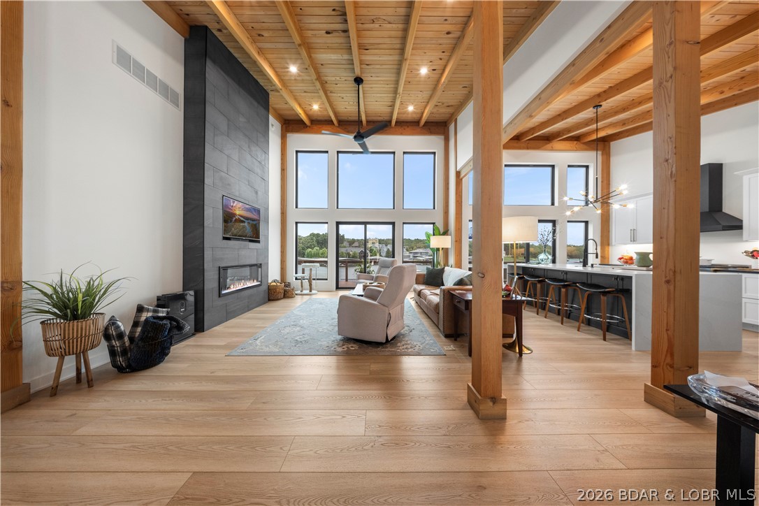 Turnkey, modern lakefront living in the heart of Osage Beach. Built in 2021 and offered fully furnished, this 4 bedroom home delivers the kind of contemporary design that’s hard to find at the Lake...without the renovation project. Soaring wood ceilings, walls of glass, and incredible lake views set the tone the second you walk in. The open main level is made for entertaining with a dramatic floor-to-ceiling fireplace, oversized kitchen island, waterfall quartz countertops, and seamless indoor/outdoor flow. The primary suite feels like its own retreat with lake views, deck access, a spa-like bath and a spacious walk-in closet. The walkout lower level offers a second living area plus a designated wet bar space that can be custom finished to fit the buyer’s style. With the seller being a licensed builder, additional upgrades or custom touches may also be considered. Outside, enjoy multiple lakeside decks, a private dock, a protected cove location, city water and sewer, and easy access to dining, shopping, golf, and entertainment by land or water. Modern, move-in ready and made for the Lake lifestyle!