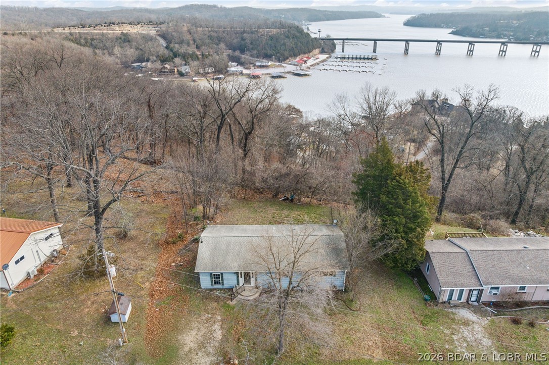 Investor/First-Time Buyer Special! Stunning Seasonal Lake View! 2 Bedroom Home + Huge Bonus Room 
Whether you are looking for a weekend getaway to customize, a savvy investment project, or an affordable first
home, this property and location are well suited for a variety of options. You are right near The Ozarks
Amphitheater, Bridal Cave and Mariners Pier 31. The home is all one level and features a functional 2-bedroom
layout with a cozy, inviting feel. The true gem is the very large, private 3rd non-conforming bedroom/bonus room
—perfect for an massive master suite, a game room, or a bunk room for guests. Selling AS IS. With a little clearing
lakeview could be year-round.