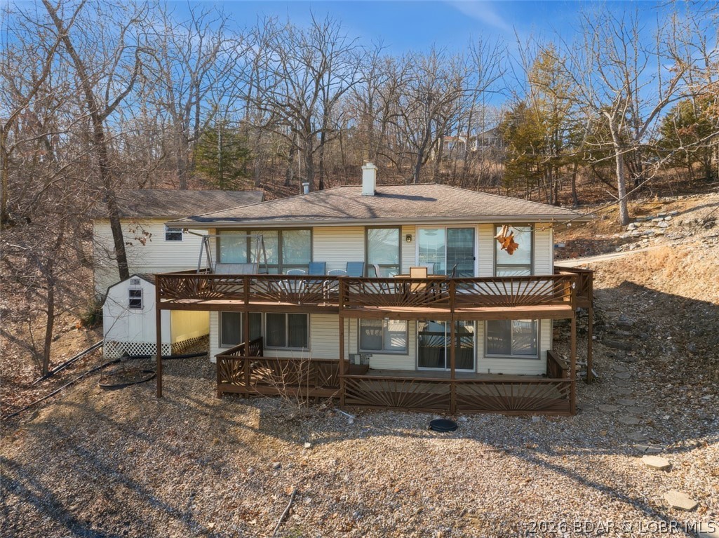 Updated Lake Front Home with Cove protection and Main Channel View.  Also, includes the 2nd Tier Lot with .72 Acres.  This Lake Home comes Furnished & the Living Room has lots of Lake View Windows, Wood Stove & Sliders to a large open deck.  The Kitchen is Tiled with extra Built-In Cabinets.  The Family Room downstairs has Rock Wall Décor, Lake View Windows and Sliders to a large Covered Deck.  2 Bedrooms & Bath upstairs and 2 Bedrooms & Bath downstairs for lots of sleeping area.  There is a Concrete Driveway, a detached 2-Car Garage, Storage Shed and easy walk to a 2-Well Dock with Boat Hoists.  The extra .72 Acre Lot can be purchased separate and could be cleared for an extra garage, guest home or extra parking.  Great location on the Lake & close to Paradise Restaurant.