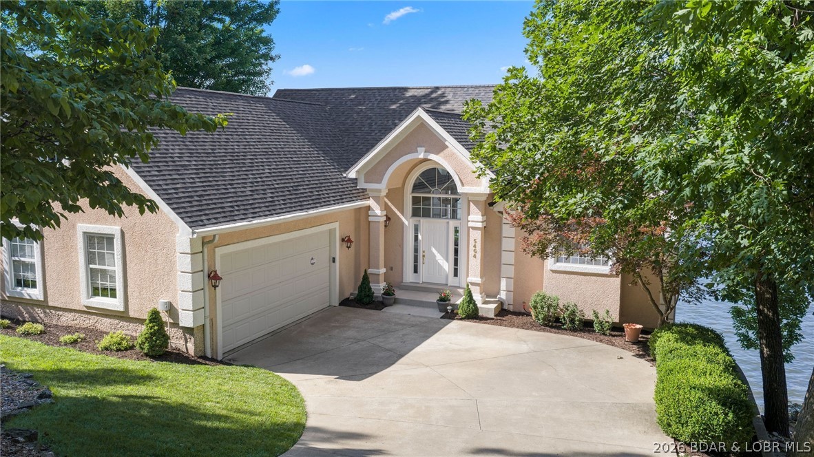 Luxury living with breathtaking views at the 20 MM of the Lake of the Ozarks, MO. This exceptional lakefront home captures panoramic main channel views and an unforgettable Lake of the Ozarks lifestyle. Lovingly maintained by its original owner, this meticulously cared-for 4-bedroom, 3 full and 2 half-bath home, built in 2002, showcases soaring vaulted ceilings, a gourmet kitchen, a spacious main-level primary suite, and a walkout lower level complete with a second living area, wet bar, and built in ice maker—perfect for entertaining family and friends. Expansive covered and screened decks provide the ideal place to relax and take in the spectacular scenery. Located in the gated community of The Ledges, residents enjoy pickleball courts, privacy, and a prime location just minutes from the Lake's best waterfront restaurants, golf, shopping, and entertainment. This is a rare opportunity to own a stunning bluff-top retreat where luxury, exceptional care, and breathtaking views come together. Call for a private showing today!