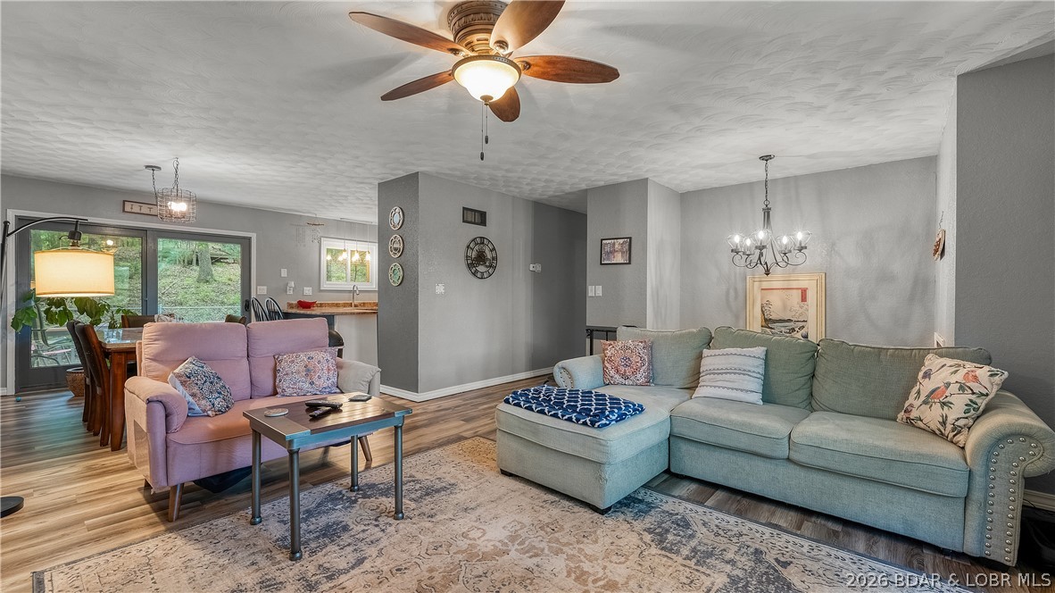 Great Horseshoe Bend location, nearly an acre of wooded ground, and room for the whole family! This second-tier home sits just across the road from the Lake and offers 4 bedrooms (1 nonconforming with no window), 2 large bathrooms, and plenty of space to spread out. Whether you're looking for a full-time residence, weekend getaway, or investment opportunity, this property offers flexibility that's hard to find. Located outside Four Seasons, it could make an excellent long-term or vacation rental. Enjoy peaceful mornings on the deck, evenings in the fenced backyard with your pets, and the privacy of a large wooded lot. Major improvements include a new roof (2021), new windows (2022), updated flooring, newer appliances, water heater, water softener, front porch, shower, and plumbing improvements. New septic line installed in 2017. The home is all electric, with Summit Natural Gas nearby, community well service in place, and city water available at the road. If you've been searching for an affordable home with space, privacy, updates, and a desirable Lake location, this is one you won't want to miss. Schedule your showing today!