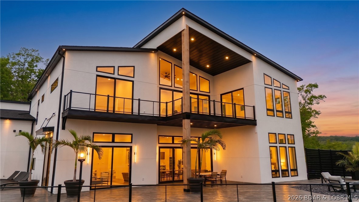Breathtaking main channel views of the Osage 24MM while also having a COVE protected dock! This NEW build estate is designed for luxury entertaining & refined everyday living. Encompassing 9,153 sq ft under roof, property includes 5,431 sq ft of sophisticated living space & an impressive 3,722 sq ft heated/cooled garage; ideal for showcasing cars, boats or the ultimate entertainment lounge. Interior features a chef’s kitchen with a 64” side-by-side refrigerator/freezer, waterfall granite island & slab backsplash, designer lighting & a one-of-a-kind floating metal staircase w/ wood treads--following the natural curve of the trunk going up the staircase. Primary suite is a private retreat with breathtaking lake views & a spa-inspired bath with marble flooring & a distinctive open shower / soaking tub concept & desirable walk-in closet w/ custom shelving. Outdoor living feels like a private resort with its 40x16 pool, hot tub, tanning ledges and fountains, covered cabana, stamped concrete, torch-lit pedestals surround pool deck, finished w/ a fire pit. Exterior finished in stucco & stone, a flat driveway, sought after location by land/water & a massive private dock. A true masterpiece