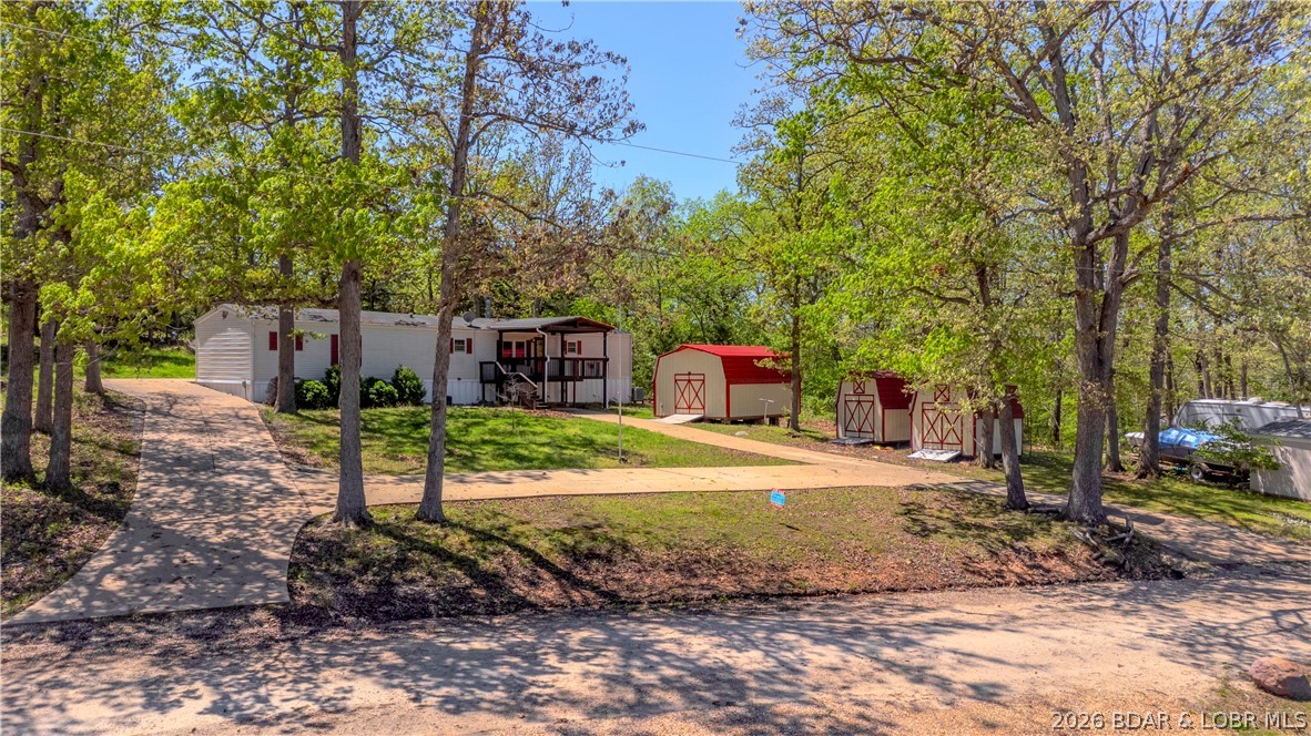 Enjoy the best of lake-area living at the 45MM, offering a perfect mix of comfort and opportunity. The home features one-level living with an open floor plan designed for gathering and relaxation, highlighted by a cozy living area with a wood-burning fireplace. Set on a spacious lot with a large front yard, the property includes three storage sheds offering ample space for tools and lake gear, along with a covered front patio that’s perfect for enjoying your morning coffee or unwinding after a day on the water.

This property has an additional lot with 75 feet of lake frontage, with electricity already installed, providing added value, privacy, and the potential to build your own custom dream home!

You’ll enjoy easy access by both land and water to local favorites, with nearby lakefront spots like Captain Ron's Bar & Grill and The Fish and Company, as well as outdoor attractions including Ha Ha Tonka State Park. Spend your days boating, fishing, or exploring the quieter coves nearby, and your evenings unwinding under the stars in a peaceful, low-traffic setting—this property delivers flexibility, charm, and a relaxed lake lifestyle.